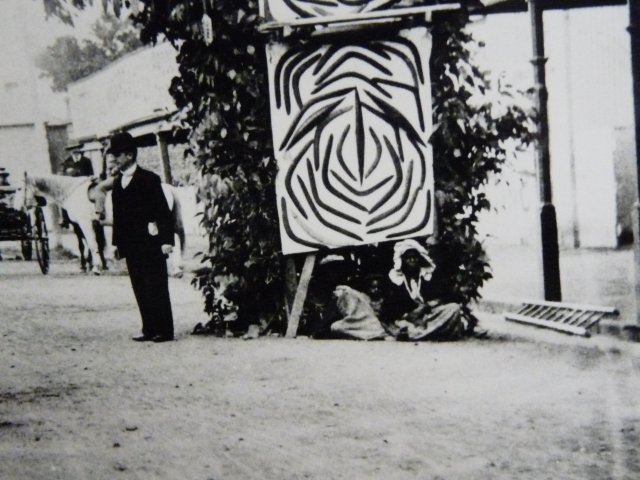 Unnamed Aboriginal woman in front of "Budget" welcome arch, Singleton 1904. Australian Museum.